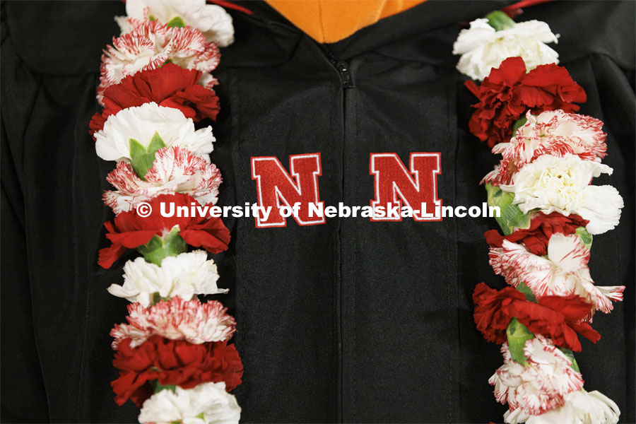 John Farag added color to his regalia with a red and white lei. Graduate Commencement at Pinnacle Bank Arena. December 17, 2021. Photo by Craig Chandler / University Communication.