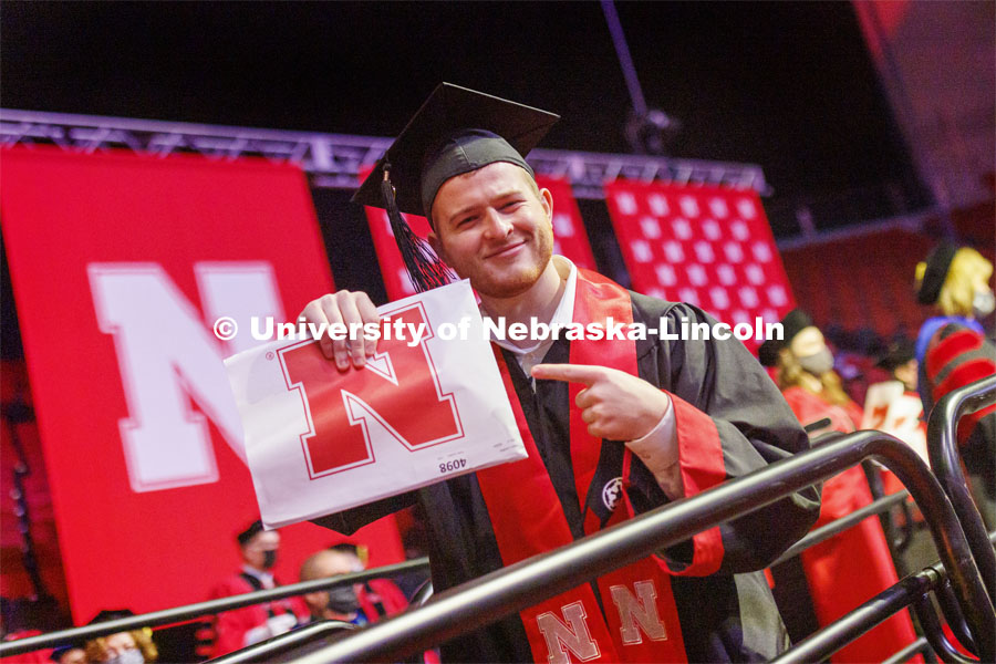 Gabe Luedke shows off his CoB diploma. Undergraduate Commencement at Pinnacle Bank Arena. December 18, 2021. Photo by Craig Chandler / University Communication.