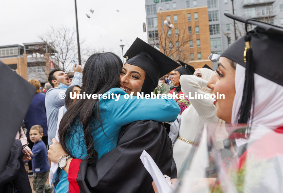 Maathar Said Abdul Rahman Al Balushi celebrates her business degree after the ceremony. Undergraduate Commencement at Pinnacle Bank Arena. December 18, 2021. Photo by Craig Chandler / University Communication.
