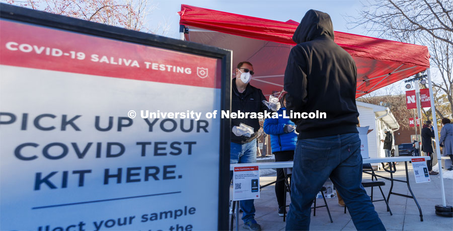 Robert Kelly and other volunteers hand out testing kits to lessen waiting time at the Nebraska Union testing site. COVID-19 testing is for all faculty, staff and students who have an on-campus presence for the spring 2022 semester begins January 9. January 10, 2022. Photo by Craig Chandler / University Communication.