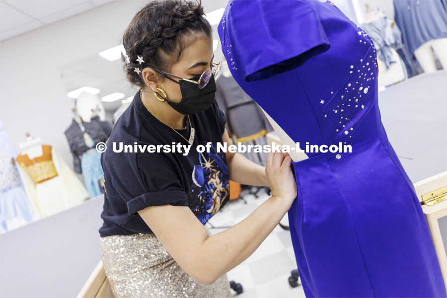Adria Sanchez-Chaidez, a graduate student in Textiles, Merchandising and Fashion Design, pins her Star Trek-inspired dress, “Boldly Go”, one of her geek couture designs, onto a mannequin. January 21, 2022. Photo by Craig Chandler / University Communication.