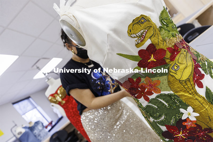 Adria Sanchez-Chaidez, a graduate student in Textiles, Merchandising and Fashion Design, pins “Destination Isla Nublar”, one of her geek couture designs, onto a mannequin. January 21, 2022. Photo by Craig Chandler / University Communication.