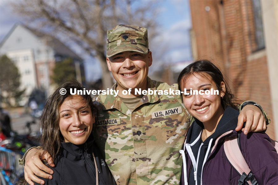 Spc. Allen Castaneda with his sisters, Priscila, left, and Leslie at the end of her criminal justice classes today. Castaneda returned early from his deployment with the Army Reserves. January 27, 2022. Photo by Craig Chandler / University Communication.