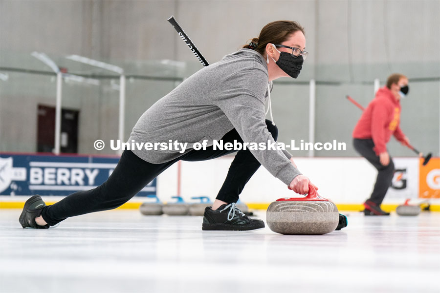 Kylee Hauxwell serves during curling practice at the John Breslow Ice Hockey Center. Curling Club. February 1, 2022. Photo by Jordan Opp for University Communication.