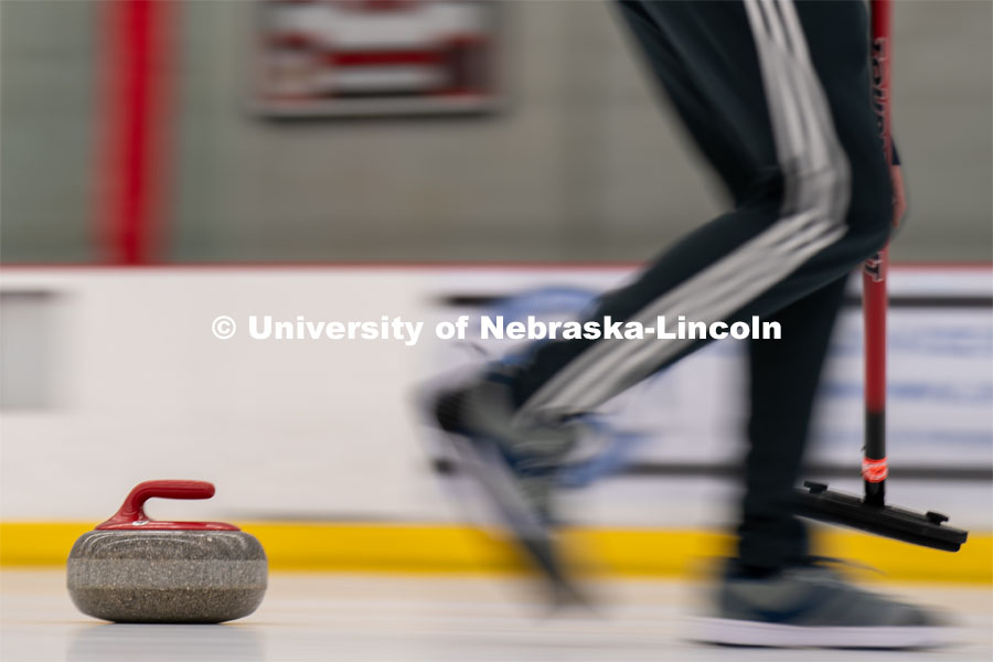 A curling stone moves across the ice at the John Breslow Ice Hockey Center. Curling Club. February 1, 2022. Photo by Jordan Opp for University Communication.