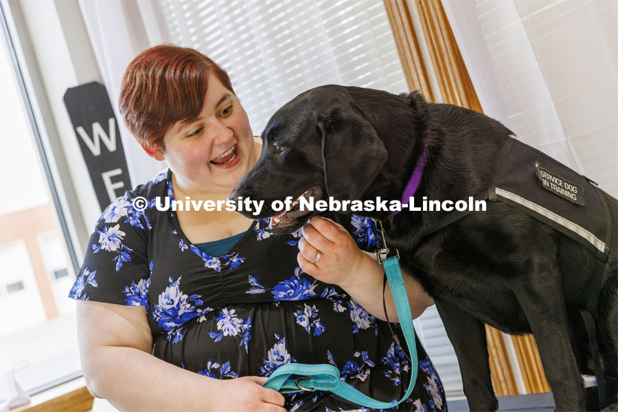 Liz Higley, a 2019 Animal Science grad and owner of Uplifting Paws, poses with Freddie, a service dog she is training. February 2, 2022. Photo by Craig Chandler / University Communication.