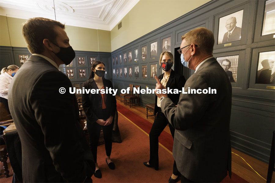 Ryan Sullivan, clinical associate professor of law (left), and Kevin Ruser, professor of law and director of clinical programs (right), talk with Nebraska Law students Jayden Barth and Rachel Tomlinson Dick after their arguments were finished. The two students argued a case before the Nebraska Supreme Court today. Both are third-year students mentored by Law Professor Ryan Sullivan. February 4, 2022. Photo by Craig Chandler / University Communication.