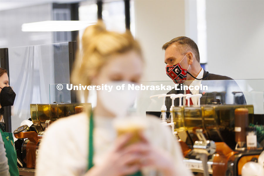 Chancellor Ronnie Green waits for his coffee at the Nebraska East Union Starbucks. Chancellor Green provided free drip coffee from Starbucks on City and East campuses in celebration of Glow Big Red. February 16, 2022. Photo by Craig Chandler / University Communication.