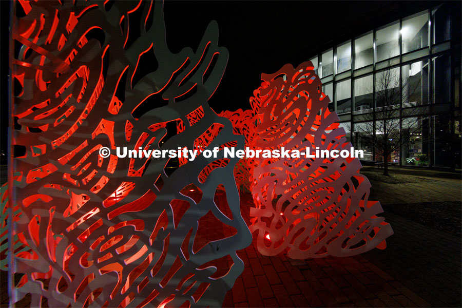 The sculpture Reverie is lit up red outside the  International Quilt Study Center and Museum for Glow Big Red. February 16, 2022. Photo by Craig Chandler / University Communication. 