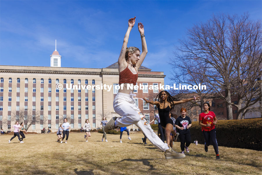 Susan Ourada’s Modern Dance 1 and 2 classes leap into the warm weather of the first day of March on the lawn outside Love Library. March 1, 2022. Photo by Craig Chandler / University Communication.
