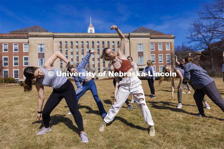 Susan Ourada’s Modern Dance 1 and 2 classes leap into the warm weather of the first day of March on the lawn outside Love Library. March 1, 2022. Photo by Craig Chandler / University Communication.