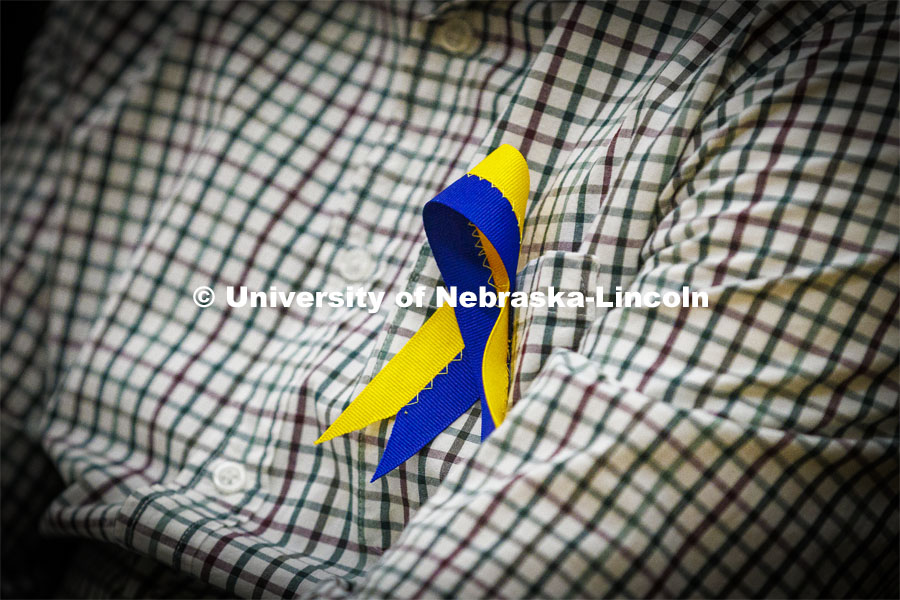 Members of the Ukrainian community in Lincoln wore blue and yellow ribbons to the event. Stand With Ukraine! panel discussion in the Nebraska Union ballroom Tuesday afternoon. March 1, 2022. Photo by Craig Chandler / University Communication.