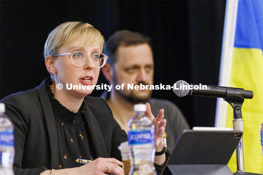 Courtney Hillebrecht, Director of Human Rights and Humanitarian Affairs, talks with the audience. In the background is Mykhailo Smyshliaiev, a member of the Ukrainian community in Lincoln. Stand With Ukraine! panel discussion in the Nebraska Union ballroom Tuesday afternoon. March 1, 2022. Photo by Craig Chandler / University Communication.
