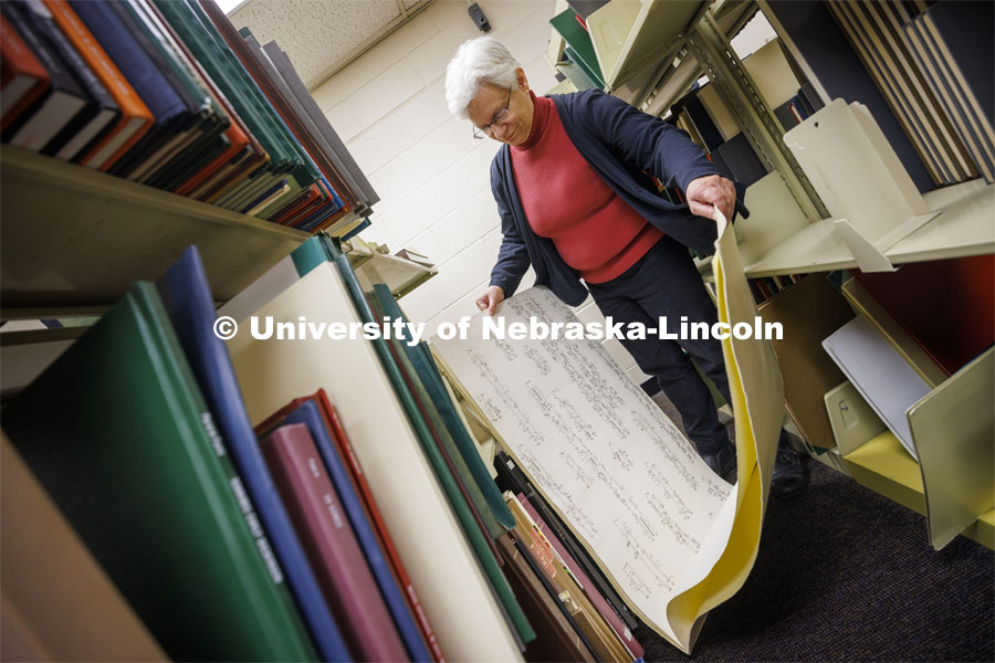 Anita Breckbill, professor, holds one of the largest scores in the collection: Karlheinz Stockhausen’s Nr. 7, Klavierstuck XI. Breckbill oversees the Hixon-Lied School of Fine and Performing Arts music library in the basement of the Westbrook Music Center. March 18, 2022. Photo by Craig Chandler / University Communication.