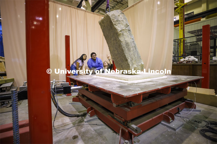 Christine Wittich talks with students as they position a slab on a large shake table in the structures lab. College of Engineering photo shoot. March 22, 2022. Photo by Craig Chandler / University Communication.