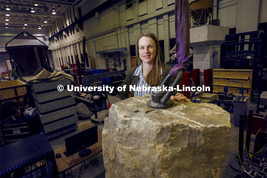 Christine Wittich, Assistant Professor of Civil and Environmental Engineering, with a slab on a large shake table in the structures lab. College of Engineering photo shoot. March 22, 2022. Photo by Craig Chandler / University Communication.