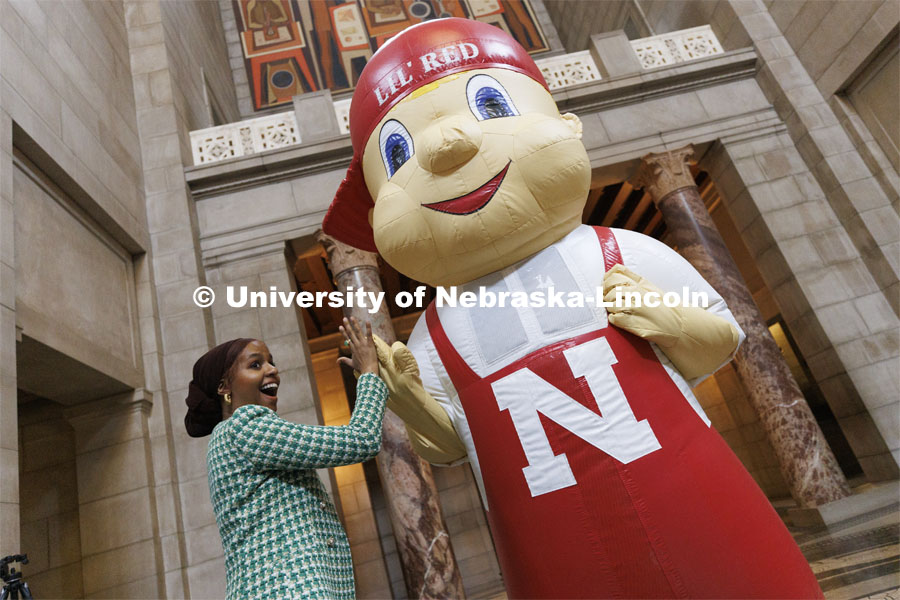 ASUN President Batool Ibrahim high fives Lil’ Red. The day ended with participants mingling in the rotunda to meet with state senators and take photos with campus mascots. Fifth annual “I Love NU” advocacy event at the Nebraska State Capitol. March 23, 2022. Photo by Craig Chandler / University Communication.