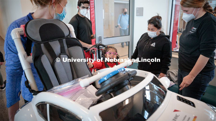 Four-year-old Dayana Torres gets a first look at the new, battery-powered car that UNL and UNMC students modified for her. Twice yearly, Nebraska’s Go Baby Go chapter modifies kid-sized battery powered cars for children with movement difficulties, providing them at no cost to the families. Nebraska’s GoBabyGo! chapter is funded by the Munroe-Meyer Guild. The program is a partnership between MMI's Department of Physical Therapy, the University of Nebraska-Lincoln and the University of Nebraska-Omaha Engineering Department and the UNMC College of Allied Health Professions/Physical Therapy students. The event took place on at the MMI building at 69th and Pine Streets in Omaha on Saturday, April 2, 2022. Photo by Kent Sievers / University of Nebraska Medicine.