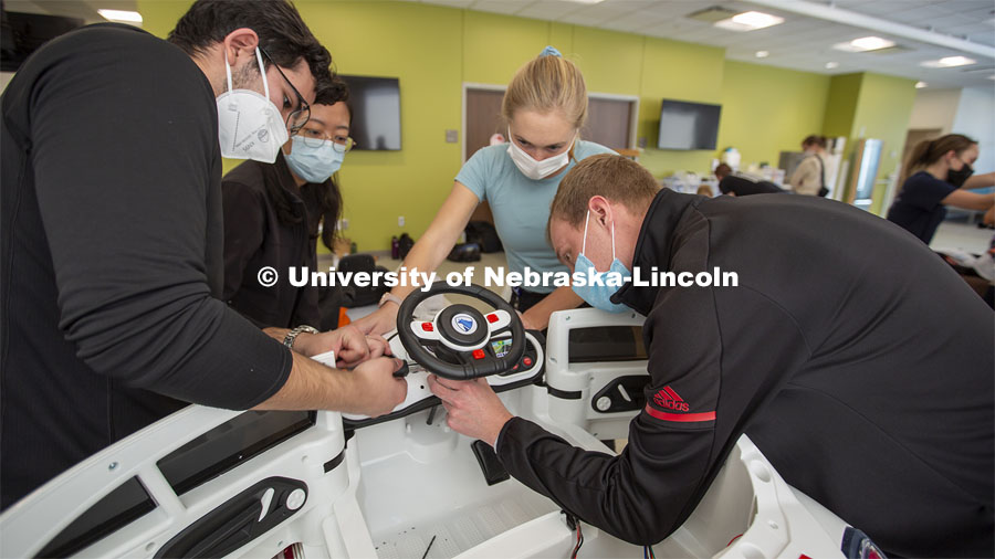 Huskers Ricardo Gato Gil (left) and Chandler Brock (right) work as a team with Yuqi Pu (second from left) and Caroline Sauer (both from UNMC) to prepare a car during the GoBabyGo! event.Twice yearly, Nebraska’s Go Baby Go chapter modifies kid-sized battery powered cars for children with movement difficulties, providing them at no cost to the families. Nebraska’s GoBabyGo! chapter is funded by the Munroe-Meyer Guild. The program is a partnership between MMI's Department of Physical Therapy, the University of Nebraska-Lincoln and the University of Nebraska-Omaha Engineering Department and the UNMC College of Allied Health Professions/Physical Therapy students. The event took place on at the MMI building at 69th and Pine Streets in Omaha on Saturday, April 2, 2022. Photo by Kent Sievers / University of Nebraska Medicine.