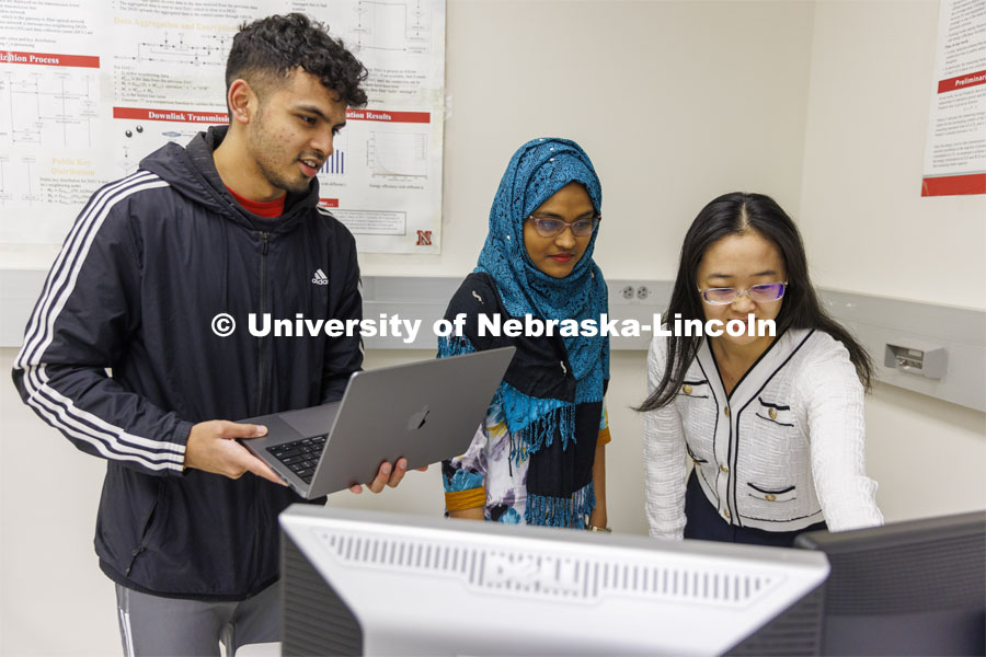 Chamath Gunawardena, Owana Manzia Moushi and Yili Jiang work on a Network and Security project. College of Engineering photo shoot at Peter Kiewit Institute in Omaha. April 5, 2022. Photo by Craig Chandler / University Communication.