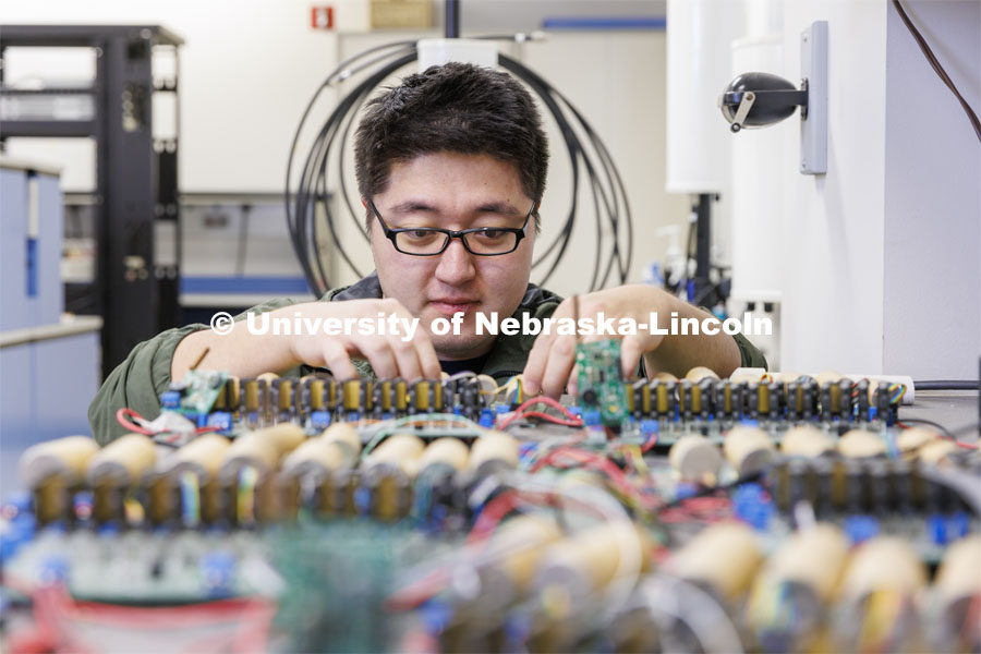 Zhenyu Meng works on a circuit board in Kuan Zhang’s IoT and AI lab. College of Engineering photo shoot at Peter Kiewit Institute in Omaha. April 5, 2022. Photo by Craig Chandler / University Communication.