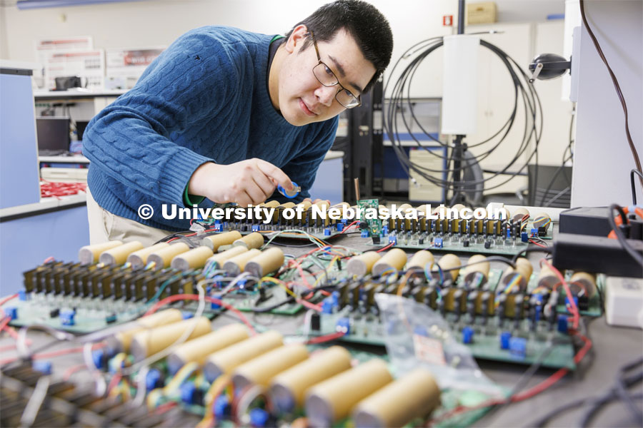 Shuaiqi Shen works on a circuit board in Kuan Zhang’s IoT and AI lab. College of Engineering photo shoot at Peter Kiewit Institute in Omaha. April 5, 2022. Photo by Craig Chandler / University Communication.