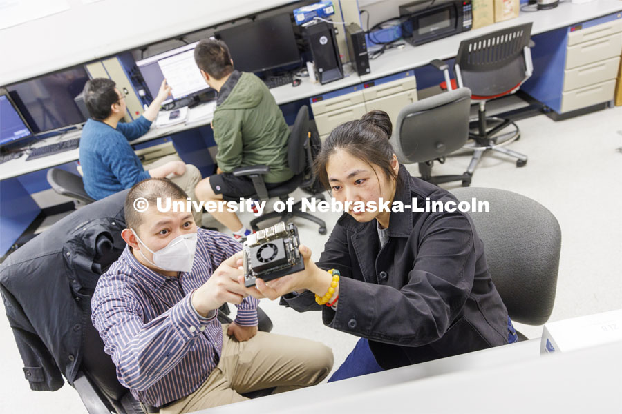Kuan Zhang, left, discusses a circuit board with Chong Yu in Zhang’s IoT and AI lab. College of Engineering photo shoot at Peter Kiewit Institute in Omaha. April 5, 2022. Photo by Craig Chandler / University Communication.
