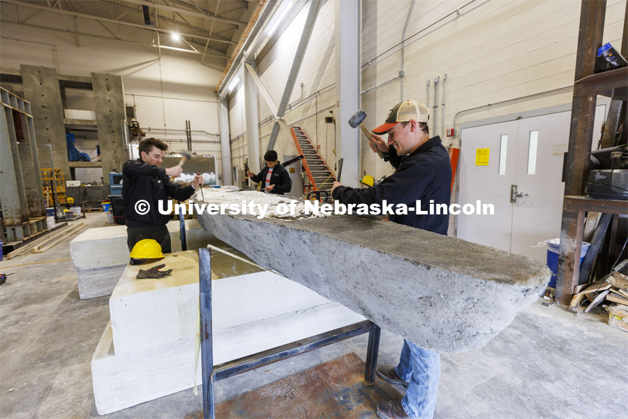 Braden Labenz, a junior from Columbus, Nebraska, works to remove the center form from the UNL concrete canoe. The canoe is part of an annual competition where engineers build a canoe from concrete that is raced against other universities. The cross section is to show the judges building techniques. College of Engineering photo shoot at Peter Kiewit Institute in Omaha. April 5, 2022. Photo by Craig Chandler / University Communication.