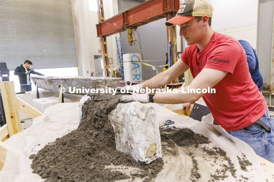 Braden Labenz, a junior from Columbus, Nebraska, works on a cross section as part of the concrete canoe race. The annual competition has engineers build a canoe from concrete that is raced against other universities. The cross section is to show the judges building techniques. College of Engineering photo shoot at Peter Kiewit Institute in Omaha. April 5, 2022. Photo by Craig Chandler / University Communication.