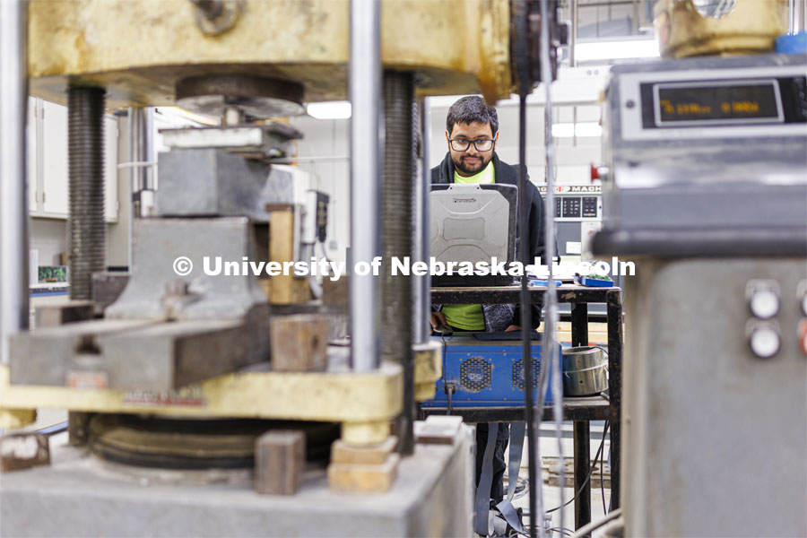 Soumitra Das compresses a sample in George Morcous’ lab. Smart phones are used to photograph the samples. College of Engineering photo shoot at Peter Kiewit Institute in Omaha. April 5, 2022. Photo by Craig Chandler / University Communication.