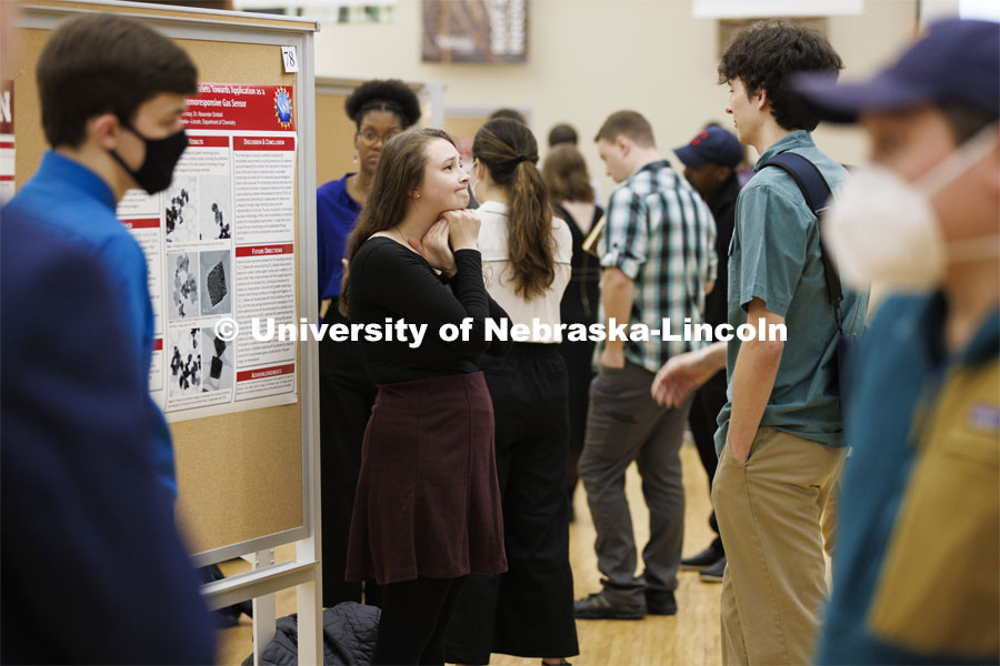 Maggie Ramsey listens to questions about her chemistry research project. Undergraduate Student Poster Session in the Nebraska Union ballroom as part of Student Research Days. April 11, 2022. Photo by Craig Chandler / University Communication.