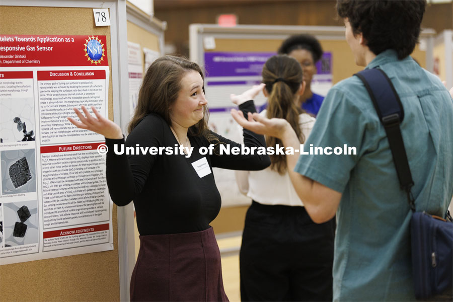 Maggie Ramsey debates her chemistry research project with a fellow student. Undergraduate Student Poster Session in the Nebraska Union ballroom as part of Student Research Days. April 11, 2022. Photo by Craig Chandler / University Communication.