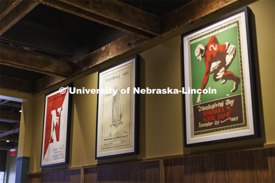 Classic Husker football posters hang in an eating space within the new Scarlet Hotel. The Scarlet Hotel on Nebraska Innovation Campus has opened. The Marriott Tribute hotel features 154 rooms, a coffee shop, signature restaurant and rooftop bar. All are open to the public. A grand opening celebration is planned for May 6. Details will be announced. April 18, 2022. Photo by Craig Chandler / University Communication.