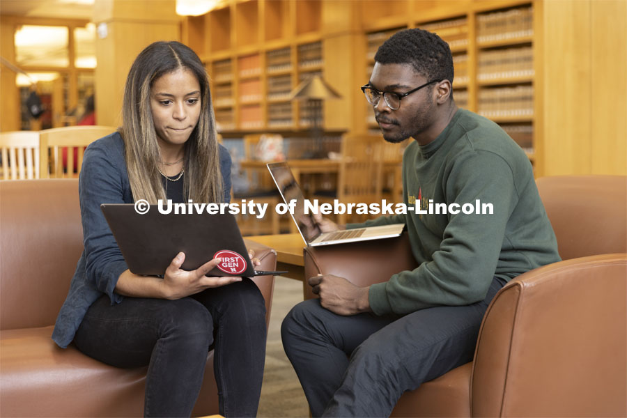 Two students compare laptop notes in the Schmid Law Library. College of Law photo shoot. April 20, 2022. Photo by Craig Chandler / University Communication.