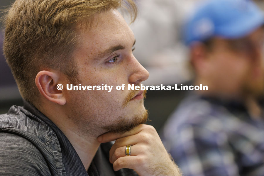 Headshot of a young man listening in class. College of Law photo shoot. April 20, 2022. Photo by Craig Chandler / University Communication.