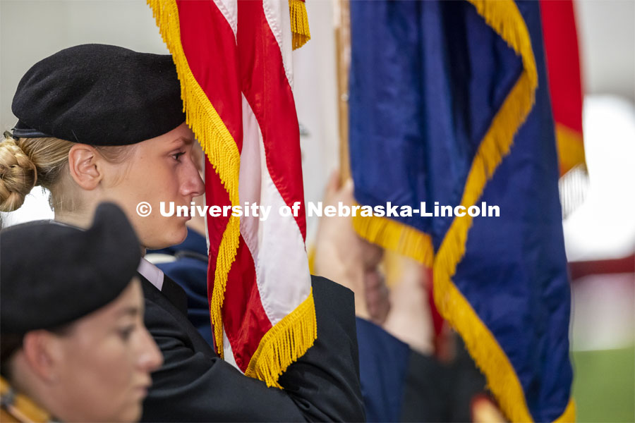 Cadet Sophie Byland holds the flag during the ROTC Joint Service Chancellor’s Review in Cook Pavilion. April 21, 2022. Photo by Craig Chandler / University Communication.