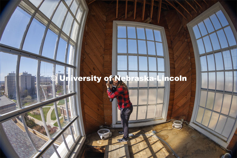 Erin Colonna, graphic designer with the University Libraries, documents signatures on the walls inside the Love Library cupola. The cupola will be renovated this summer following spring commencement. April 25, 2022. Photo by Craig Chandler / University Communication.