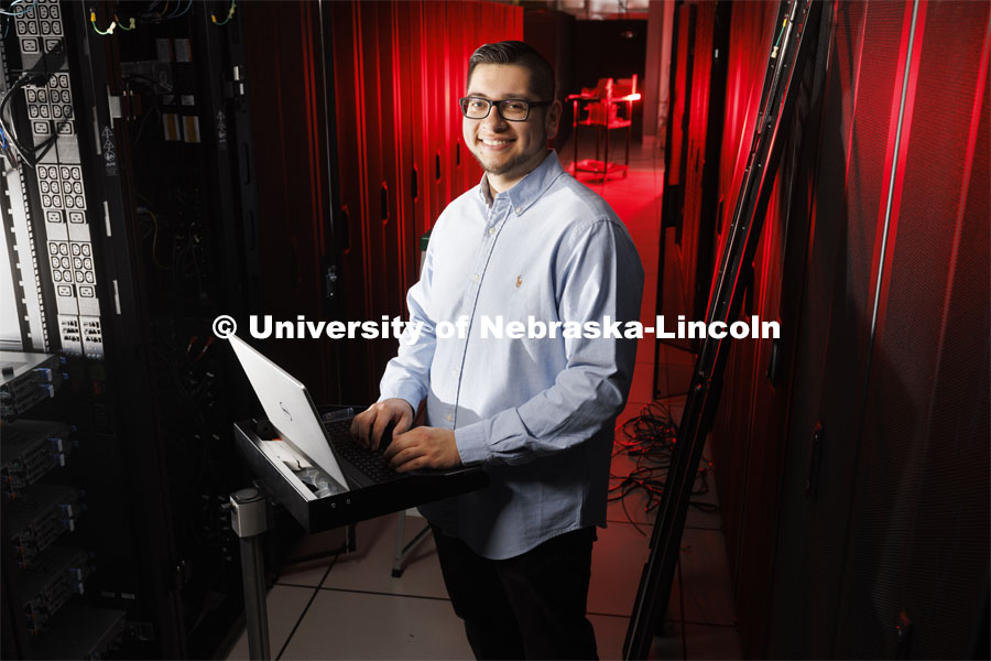 David Estrada is a senior in the school of computing. He is pictured in the serve stacks of the supecomputer in the Schorr Computing Center. He is featured in ASEM’s CoCreate website.  April 27, 2022. Photo by Craig Chandler / University Communication.