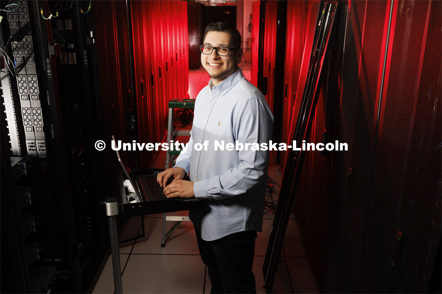 David Estrada is a senior in the school of computing. He is pictured in the serve stacks of the supecomputer in the Schorr Computing Center. He is featured in ASEM’s CoCreate website.  April 27, 2022. Photo by Craig Chandler / University Communication.