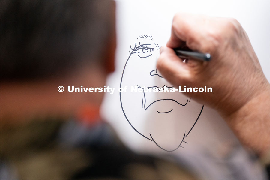 A caricature artist draws students during the End of Year Bash inside the East Campus Union on Saturday, April 30, 2022, in Lincoln, Nebraska.  Photo by Jordan Opp for University Communication
