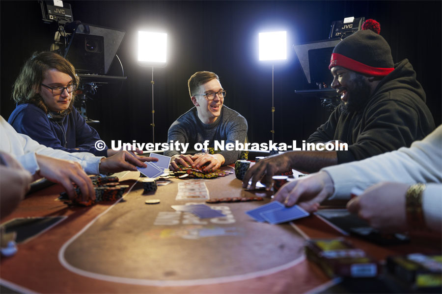 Alec Rome, rakes in the pot as Collin Streu, left, Lance Ammons, right, fold their hands. Rome, a senior in broadcasting is president of the UNL Poker Club and did a media broadcast of the Poker Club as his capstone sports production project. May 5, 2022. Photo by Craig Chandler / University Communication.