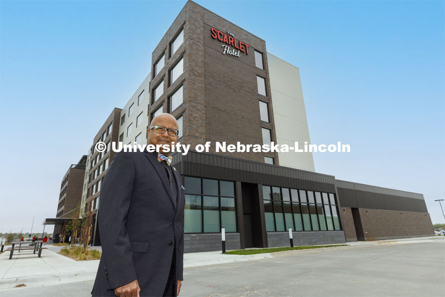 Dipra Jha stands before the completed Scarlet Hotel. As a HTRM professor, he was instrumental at getting the hotel built as a teaching hotel. Ribbon cutting for the new Scarlet Hotel in Nebraska Innovation Campus. March 6, 2021. Photo by Craig Chandler / University Communication.