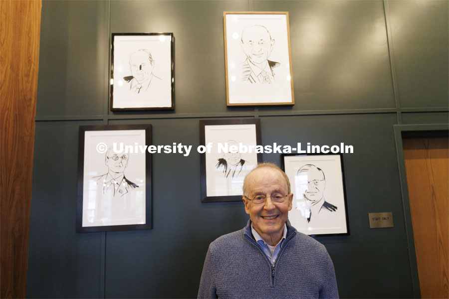 Former Chancellor Harvey Perlman stands in front of framed caricatures of former UNL Chancellors. Ribbon cutting for the new Scarlet Hotel in Nebraska Innovation Campus. March 6, 2021. Photo by Craig Chandler / University Communication.