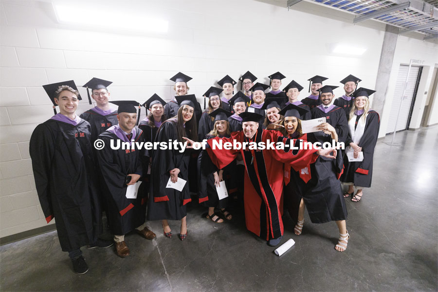 Grads pose for a group photo. Graduate commencement in Pinnacle Bank Arena. May 13, 2022. Photo by Craig Chandler / University Communication.