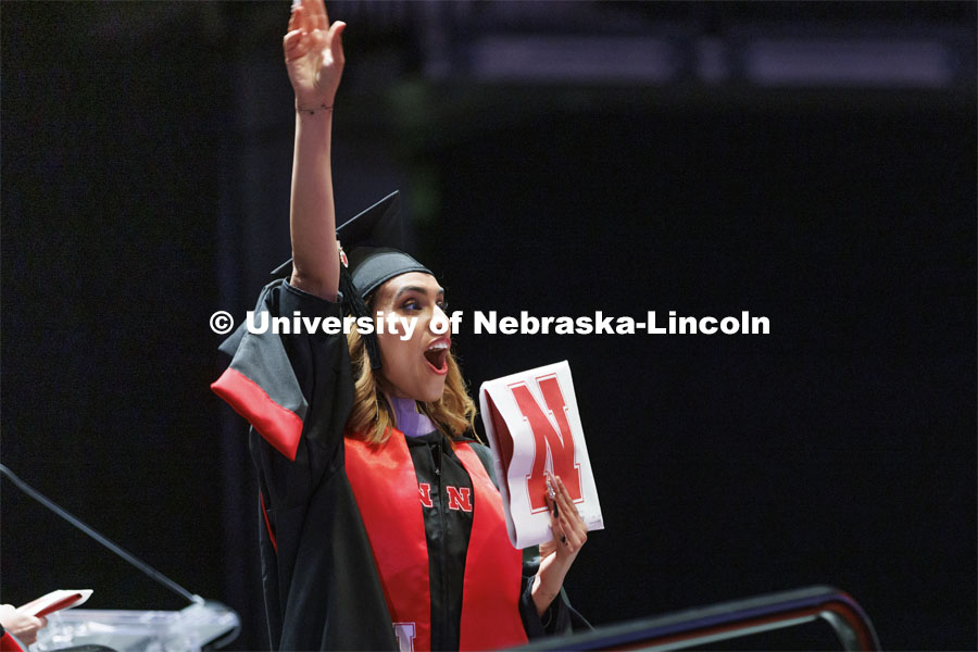 Samah Salim Al Sarhani waves to her family and friends after receiving her Masters of Architecture degree. Graduate commencement in Pinnacle Bank Arena. May 13, 2022. Photo by Craig Chandler / University Communication.