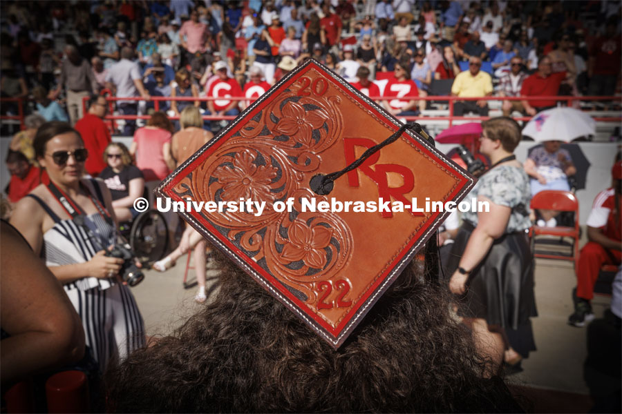Ralston Ripp’s mortar board was decorated with tooled leather. UNL undergraduate commencement in Memorial Stadium. May 14, 2022. Photo by Craig Chandler / University Communication.