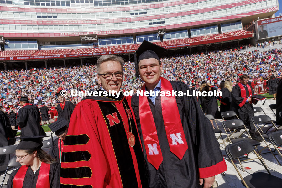 UNL Chancellor Ronnie Green chats with Grady Johnson. Johnson finished his degree online and tweeted he’d only come to commencement if the Chancellor retweeted his request. The Chancellor did and Johnson was at the ceremony Saturday. UNL undergraduate commencement in Memorial Stadium. May 14, 2022. Photo by Craig Chandler / University Communication.