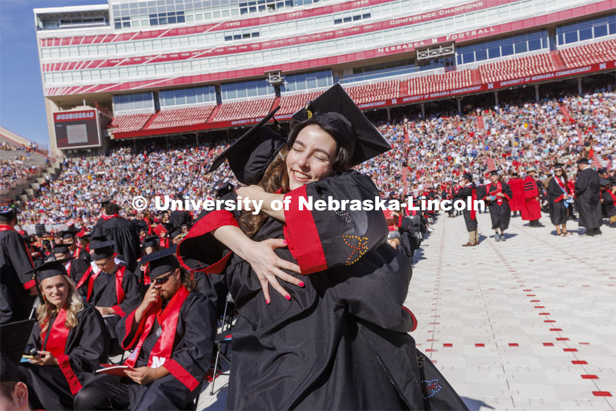 Kira Taylore hugs Olivia McCown before commencement. UNL undergraduate commencement in Memorial Stadium. May 14, 2022. Photo by Craig Chandler / University Communication.