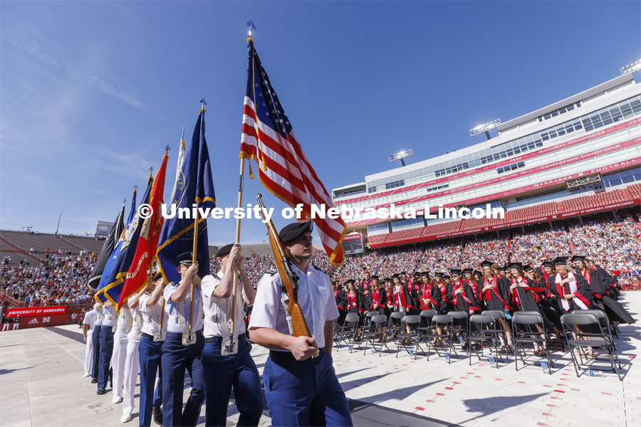 ROTC color guard marches in at the UNL undergraduate commencement in Memorial Stadium. May 14, 2022. Photo by Craig Chandler / University Communication.