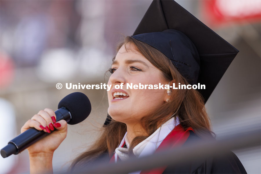 Rose Seeman sings the national anthem before the start of the UNL undergraduate commencement in Memorial Stadium. May 14, 2022. Photo by Craig Chandler / University Communication.